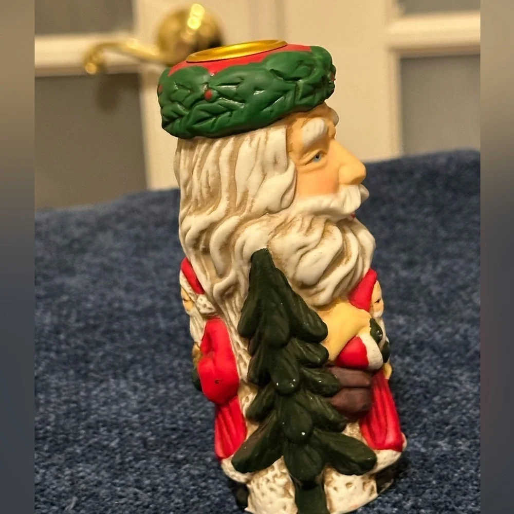 Set of 2 Santa candleholders. Each has smaller different smaller Santas.